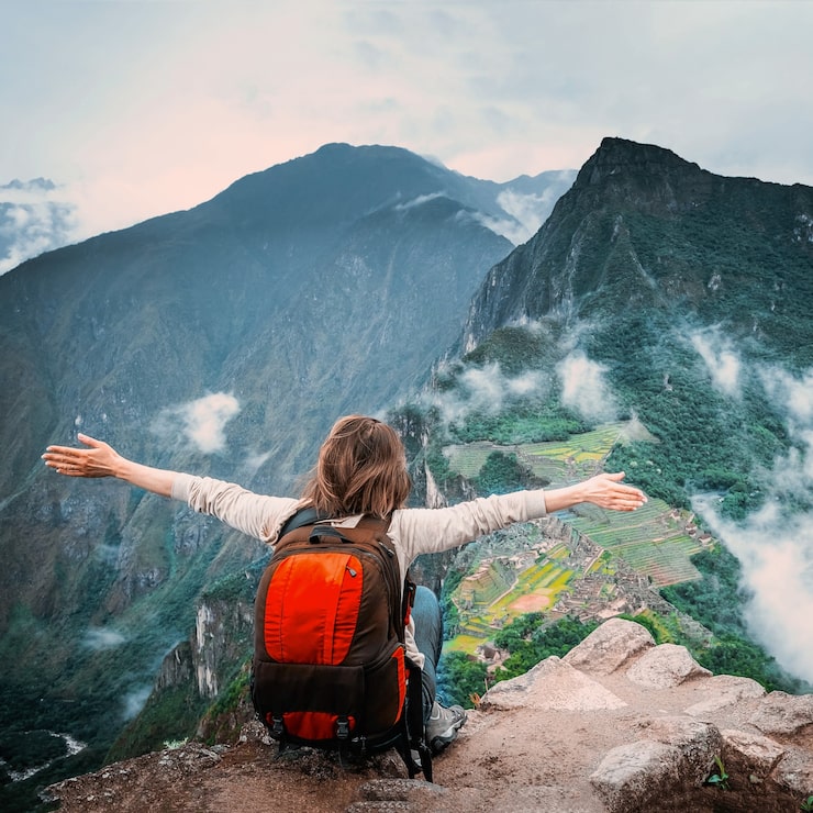 girl-sitting-edge-rock-taking-pleasure-landscape-machu-picchu_143092-1714