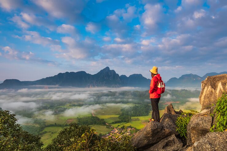young-girl-travels-high-mountain-vang-vieng-laos_46740-746